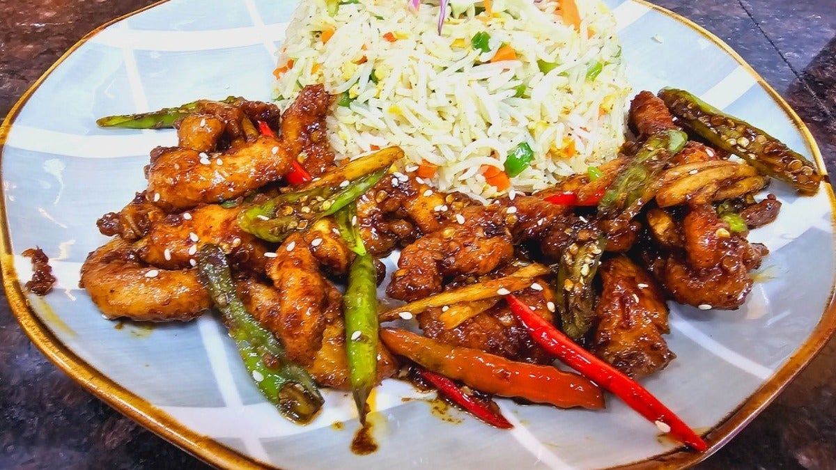 Chicken Chilli Dry, signature dish at Cock "N" Bull. Chicken Chili Dry, zesty and flavorful, a spicy delight Pakistani restaurant in Al Majarra, Sharjah, UAE